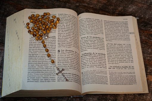 Wooden rosary with Christ in metal bible