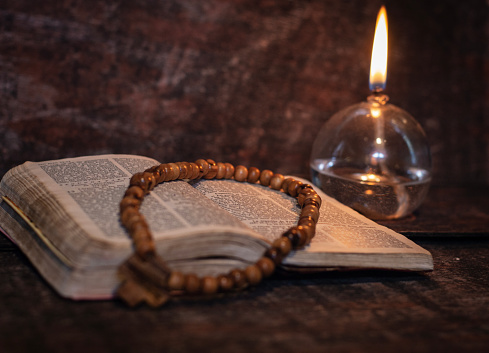 Jerusalem olive wood rosary on bible, with oil lamp, objects for prayer