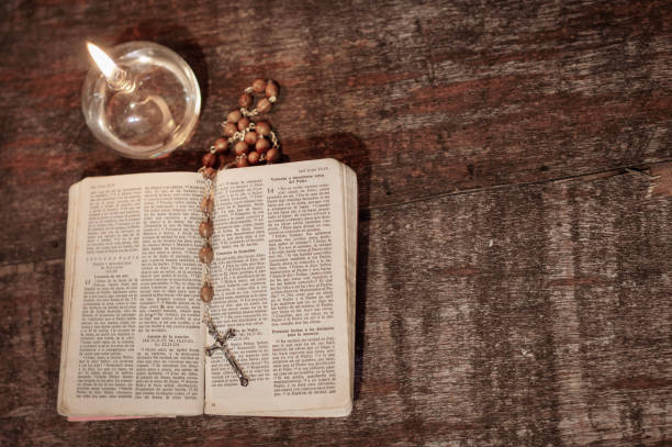 Prayer objects, Bible, rosary, lit candle, to pray with the Word of God