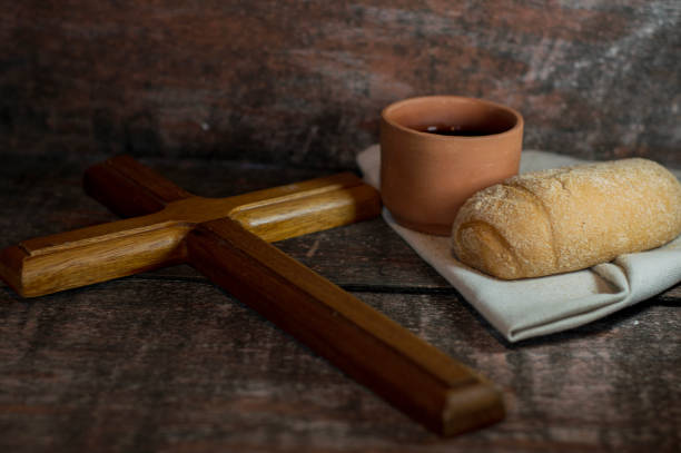 istock Wooden cross with bread and wine eucharistic symbols 2023864121