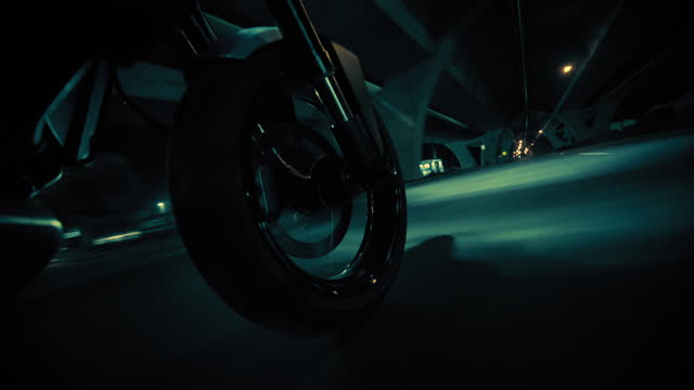 Close-up shot of motorcycles wheel while passing through the tunnel