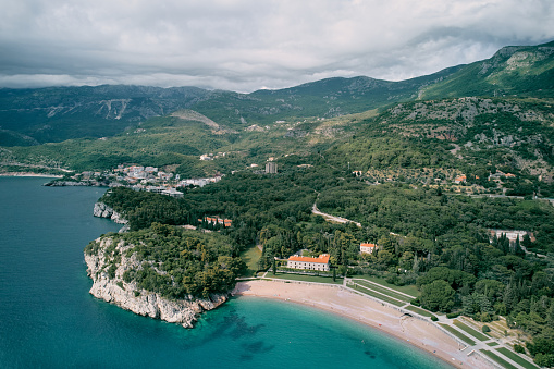 Beach and green park near Villa Milocer at the foot of the mountains. Montenegro. Top view. High quality photo