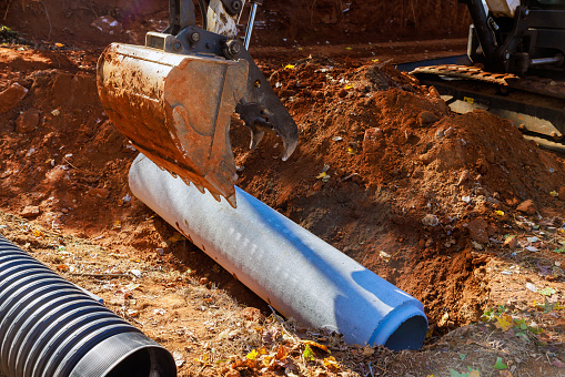 Installation of pipes at construction site that allow rainwater to flow into water main collector