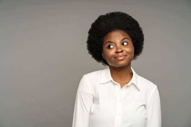 Hesitant dark skinned african american female, having skeptical thoughts to provocative statement