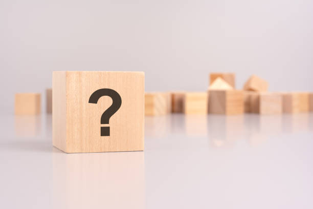 istock wooden cube with question mark over a grey background with copy space 2023965193