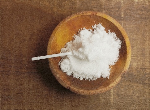 White sea salt on wood bowl