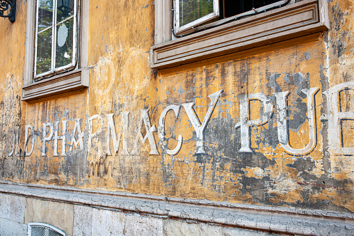 Zagreb Croatia - May 23 2011; Old dilapidated pharmacy signs on uncared for wall on city street.