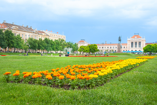 Zagreb Croatia - May 24 2011; European railway station with colourful gardens.of marigold flowers leading to station.