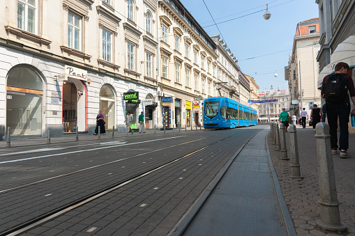 Zagreb Croatia - May 23 2011;-Blue city train in wide street on business district.
