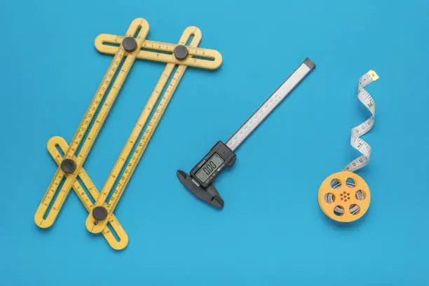 A set of measuring instruments on a blue background. A tool for accurate measurement of dimensions.