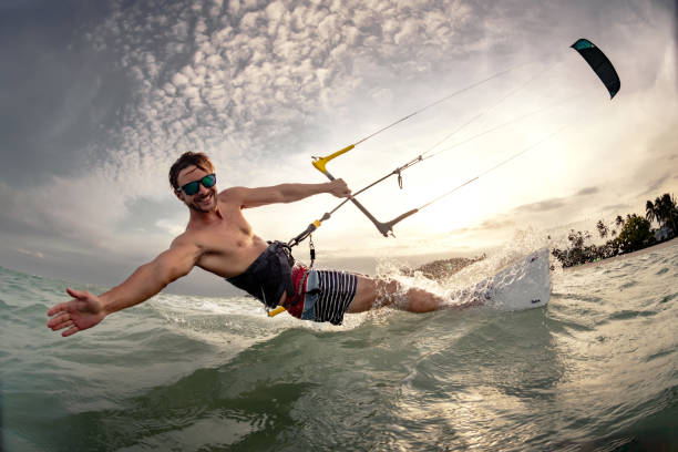 Fast kite surfer at sunset sea beach