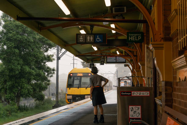Sydney, Australia, February 20, 2024- Commuters boarding a train in a rainy day at Waitara train station, NSW