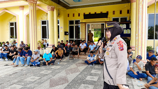 Pariaman, Indonesia - February 5, 2024 : Pariaman City Police Chief gives instructions to security officers at polling places for the 2024 election. This image is suitable for use with something on the theme of elections and government