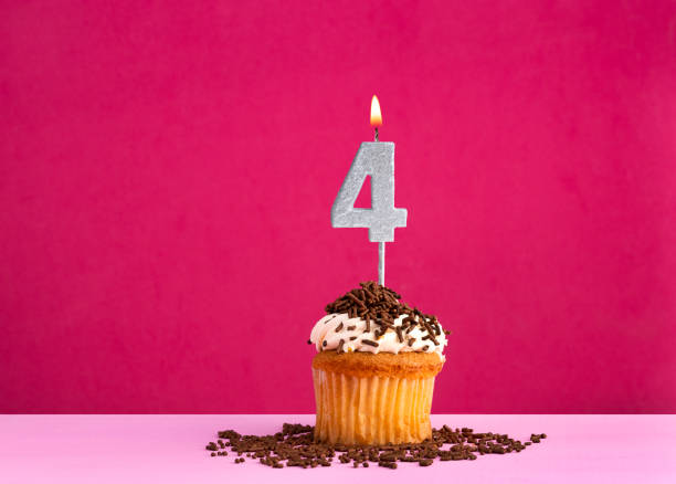 istock Birthday cupcake with candle number 4 - Birthday card on pink background 2024129996