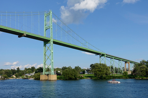 Thousand Islands bridge from a boat point of view with yacht, Ontario, Canada