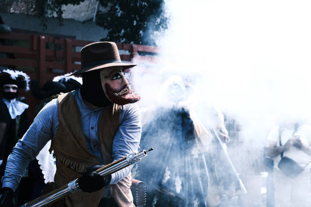 Mexico City, Mexico - February 18, 2024: Participant lit the firecracker during the local Carnaval Peñon de los Baños in Mexico City. It is an annual tradition that is celebrated before the lent.