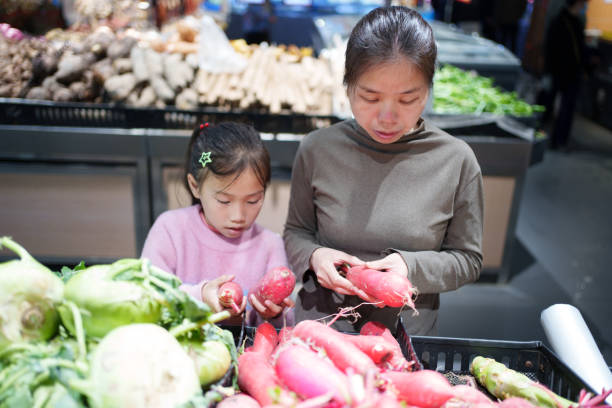 Mother and daughter shopping for radishes