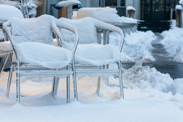 Pair of snow covered steel chairs