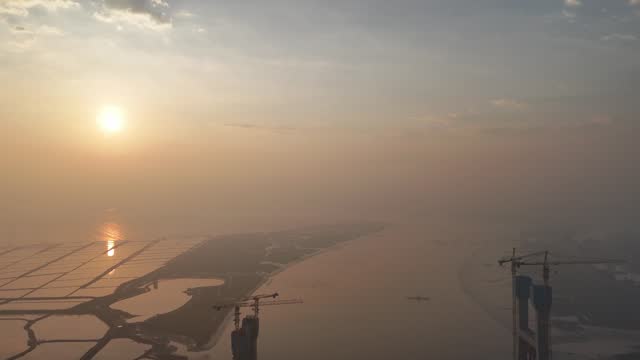 Aerial video of the under construction cross sea bridge at sunrise