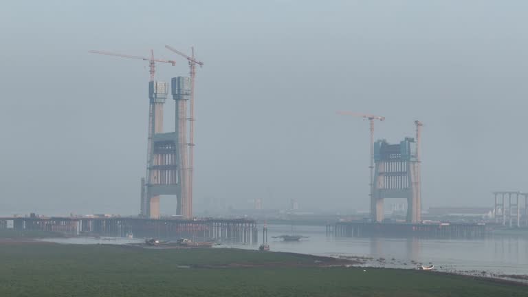 Early morning, aerial video of the under construction cross sea bridge