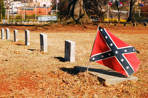 Marietta GA, USA February 28 A small confederate flag stands of the grave of a Civil War soldier at a cemetery in Marietta, Georgia