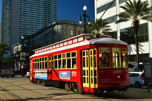 New Orleans, LA, USA June, 8 A red streetcar tram drives through the streets of downtown New Orleans carrying tourists and commuters to the French Quarter