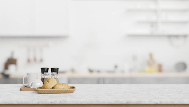 istock Marble counter top with blurred background of a minimal white kitchen. 2024303898