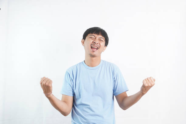 istock Asian man with a yelling expression on his face while presenting or showing discount or offer on an isolated background. Advertising concept. Copy space for text 2024315259