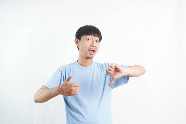 istock Young man hand showing thumbs up and thumbs down 2024315777