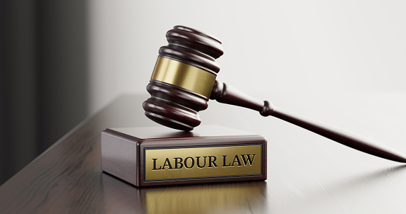 Labor Law: Judge's Gavel as a symbol of legal system and wooden stand with text word.