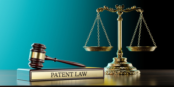 Patent Law: Judge's Gavel as a symbol of legal system and wooden stand with text word.