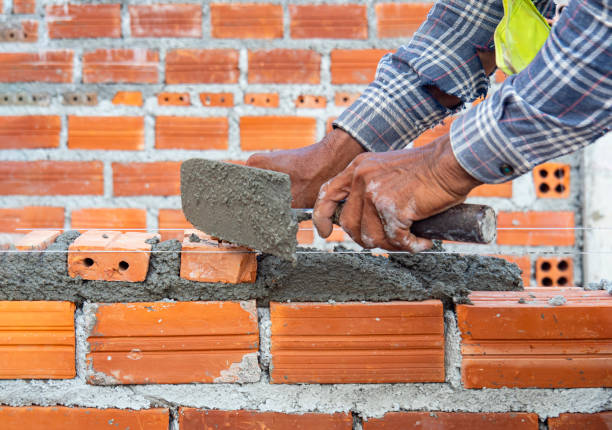 istock Masonry work, worker laying brick of an office building. Architectural work, under construction. 2024348092
