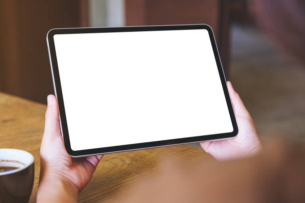 istock Mockup image of a woman holding digital tablet with blank white desktop screen 2024352758