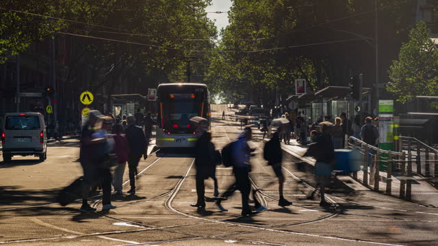 4K Footage Time lapse of Moving Tram with Crowded Commuter and Tourist waiting in rush hour, Bourke Street, down town, Southern Cross station in Melbourne, Victoria, Australia