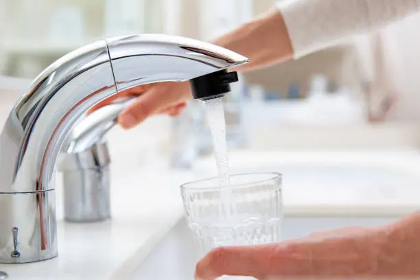 Japan's lifeline, pouring tap water into a glass,