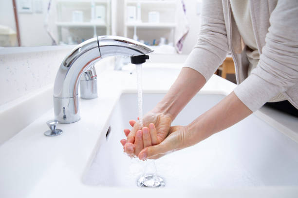 Hands of a woman washing her hands at the sink, a lifeline in Japan stock photo