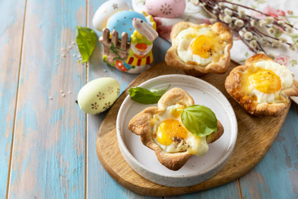 istock Scrambled eggs in puff pastry with cheese and bacon. Easter breakfast on a festive table. Copy space. 2024445889