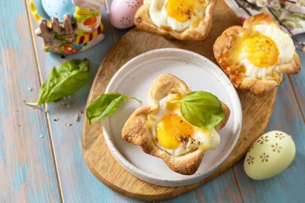 istock Scrambled eggs in puff pastry with cheese and bacon. Easter breakfast on a festive table. View from above. 2024445892