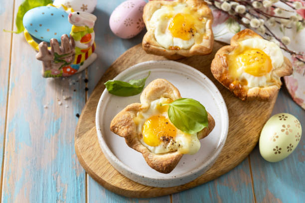 istock Scrambled eggs in puff pastry with cheese and bacon. Easter breakfast on a festive table. 2024445893