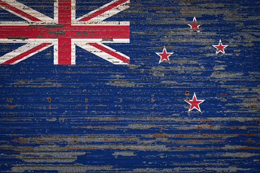 Close-up of old metal wall with national flag of New Zealand   . Concept of New Zealand   export-import, storage of goods and national delivery of goods. Flag in grunge style
