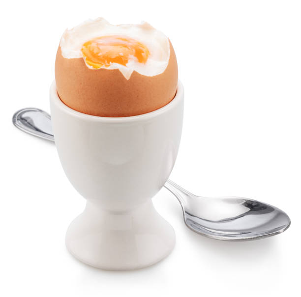 istock Brown soft-boiled cracked chicken egg in the egg cups isolated on white background. 2024459966