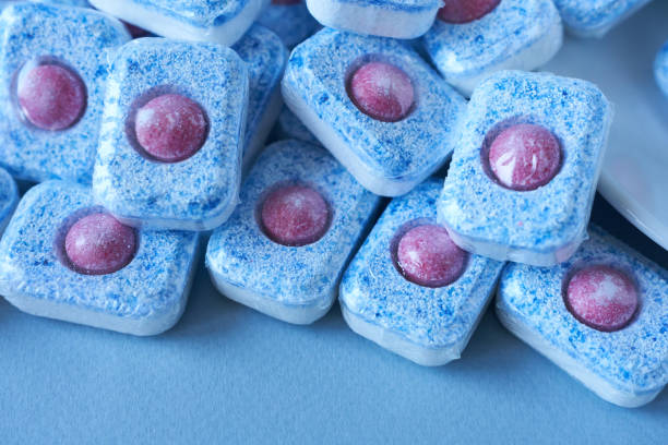 istock Dishwasher tablets on a blue background. Dishwasher detergent. 2024505248