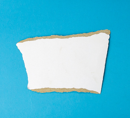 White paper teared on isolated blue background used for banner object design