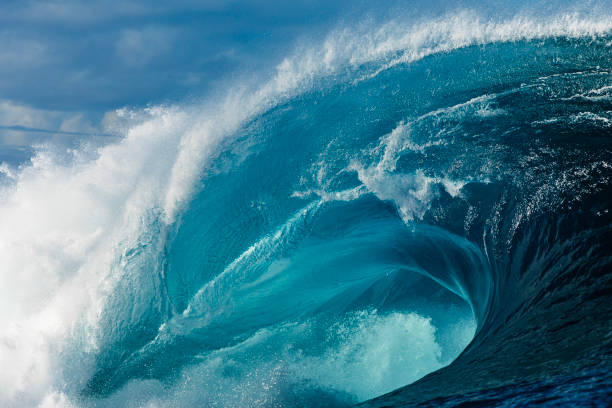 istock Close up to powerful blue wave breaking in the open ocean over a shallow reef bombora 2024531264