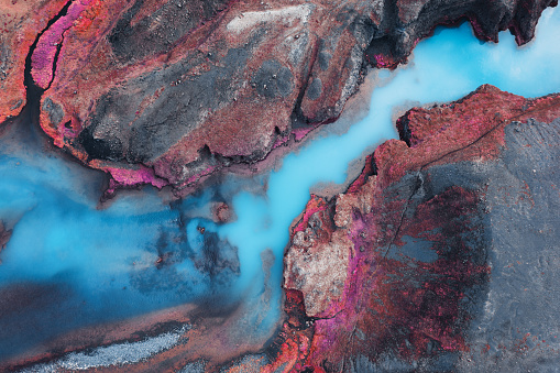 Aerial view on idyllic turquoise river in Iceland (Infrared Aerochrome look).