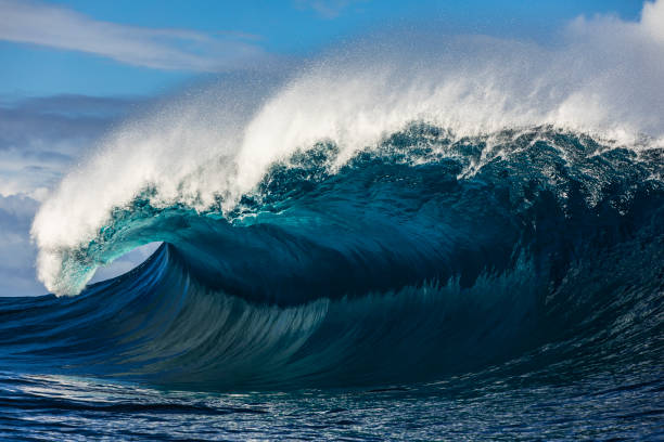 istock Close up to powerful blue wave breaking in the open ocean over a shallow reef bombora 2024547963