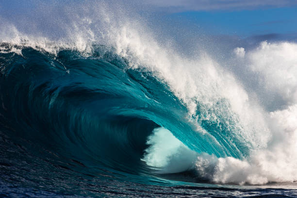 istock Close up to powerful blue wave breaking in the open ocean over a shallow reef bombora 2024549021