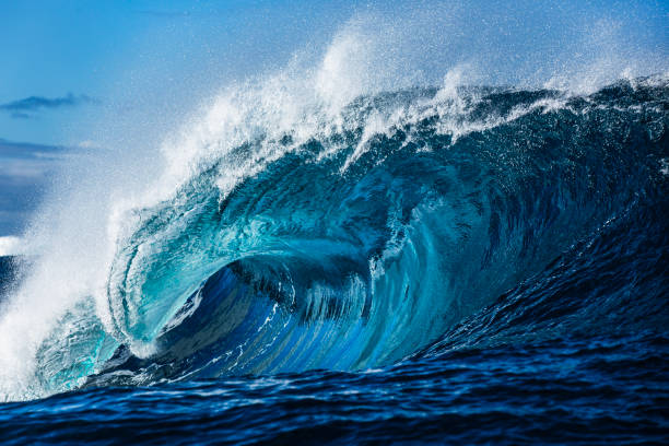 istock Close up to powerful blue wave breaking in the open ocean over a shallow reef bombora 2024557854