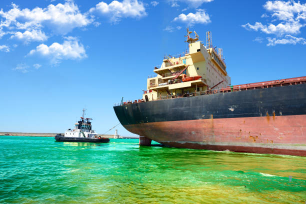 istock Tugboat helping ship in the harbor 2024564107