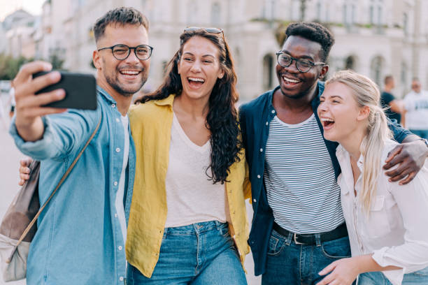 istock Friends taking selfie while walking on city street. 2024565656
